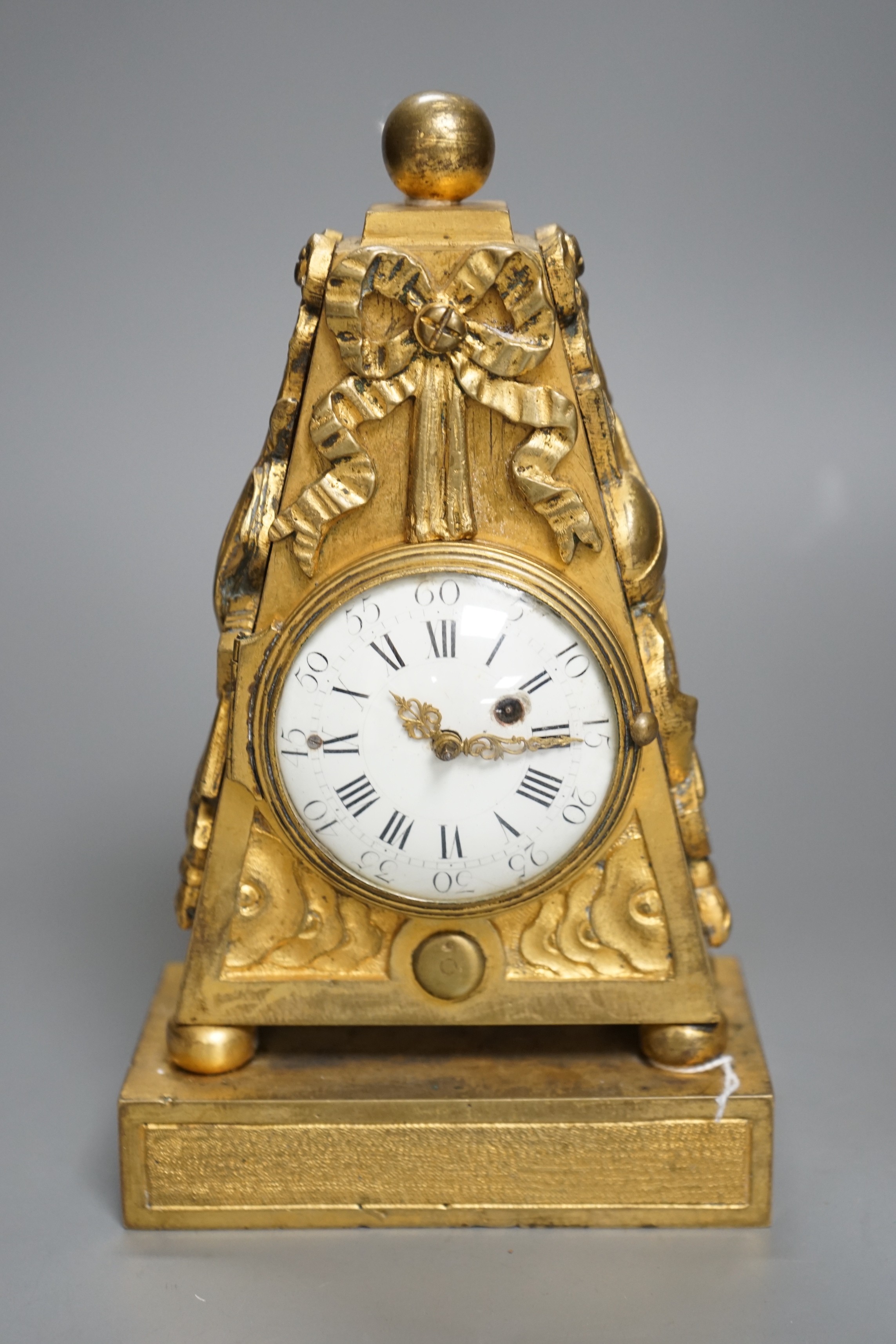 An 18th century French ormolu mantle timepiece with convex enamelled dial, 20cm